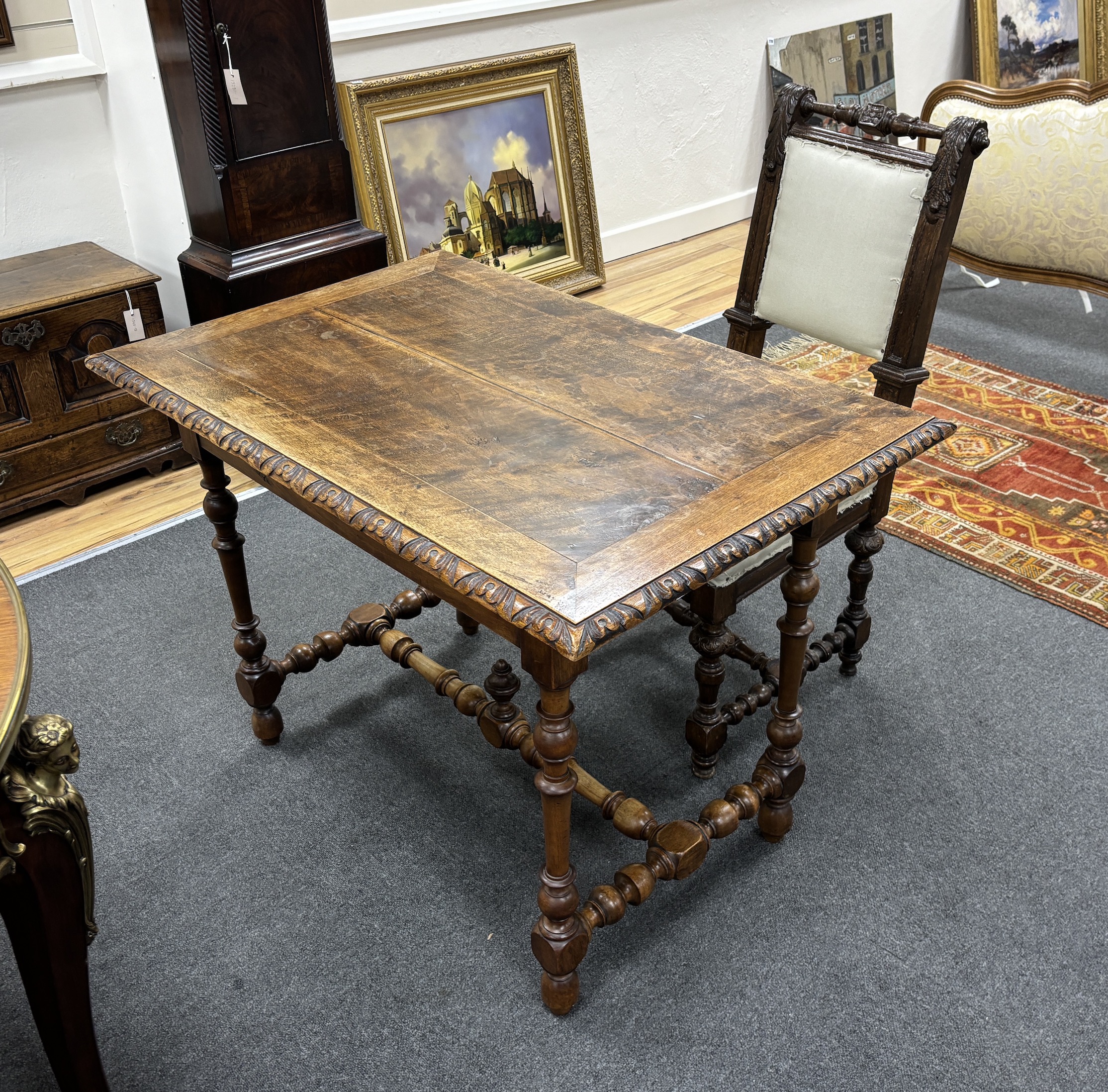 A 19th century Continental walnut side table and Flemish oak chair, table width 99cm, depth 65cm, height 71cm